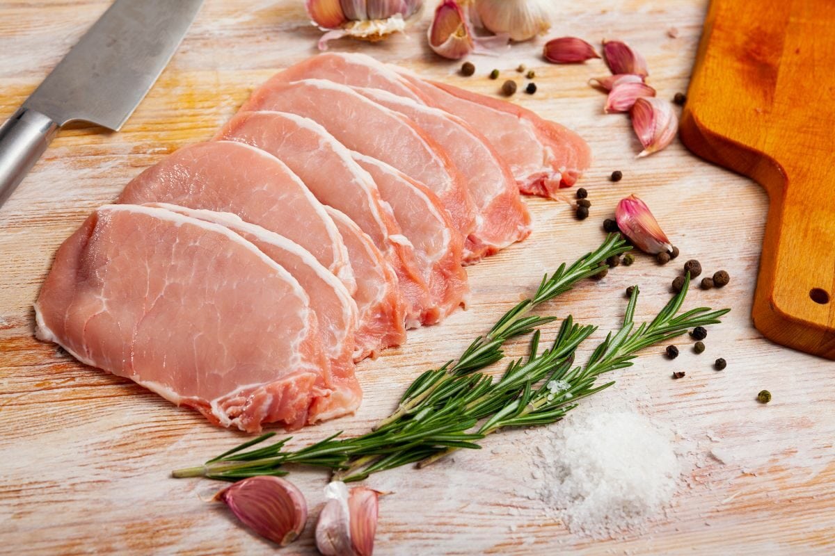 Raw Pork Chops with Rosemary Leaves