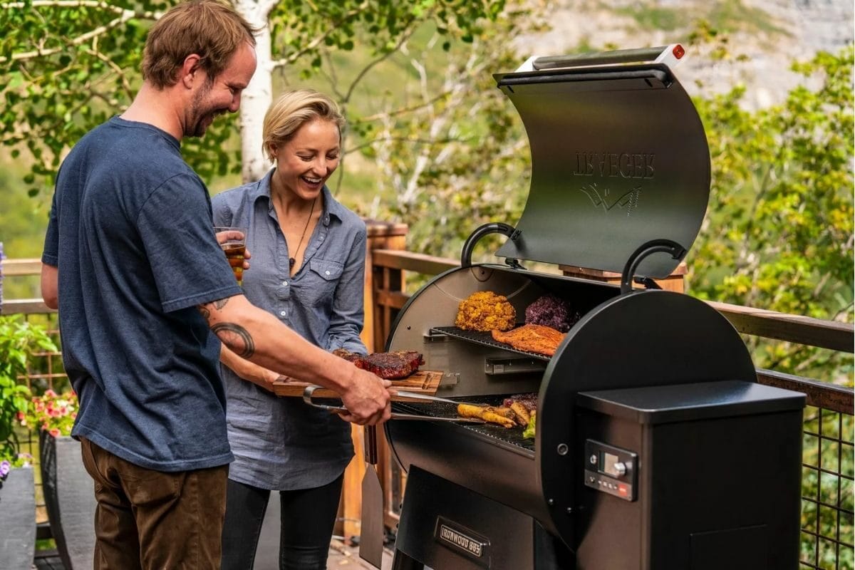 Couple Grilling Food Using Trager Ironwood Grill