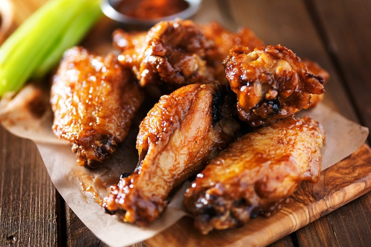 Crispy BBQ Chicken Wings on a Wooden Plate