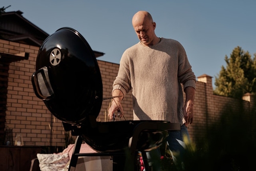 Man grilling food for the evening party