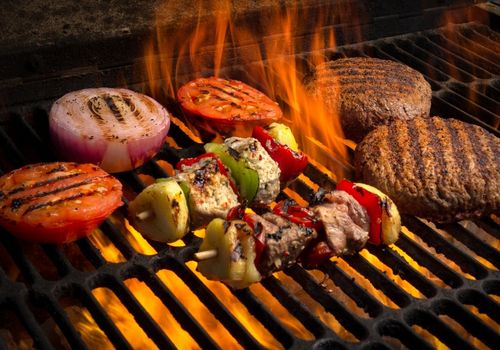 Burger, Onions and Kebabs on a Flaming Grill