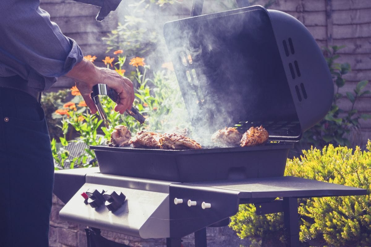 Man Grilling Meat on the Outdoor Grill