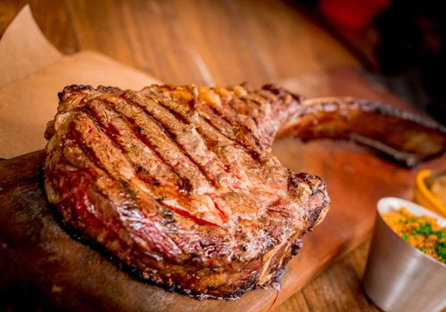 Tomahawk steak on a wooden board