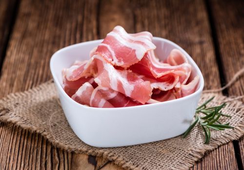 Raw Turkey Bacon in a Small White Bowl