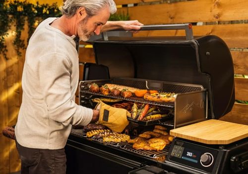 Man Smoking Meat and Veggies Using Timberline XL Grill