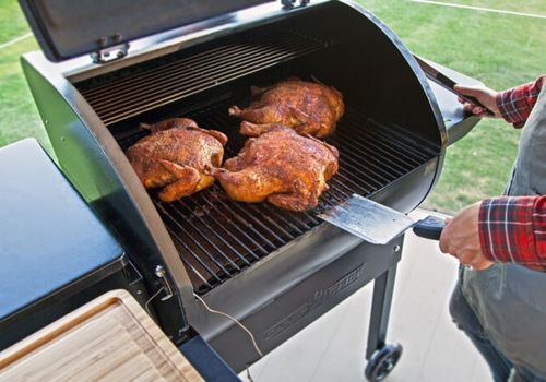 Person Smoking Chicken Using Camp Chef Portable Pellet Grill