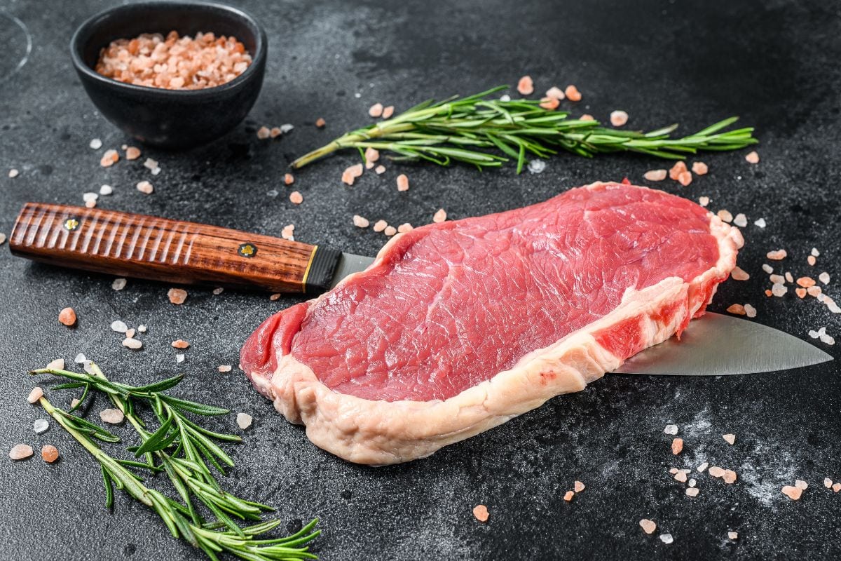 Raw Meat on Knife with Herbs and Spices