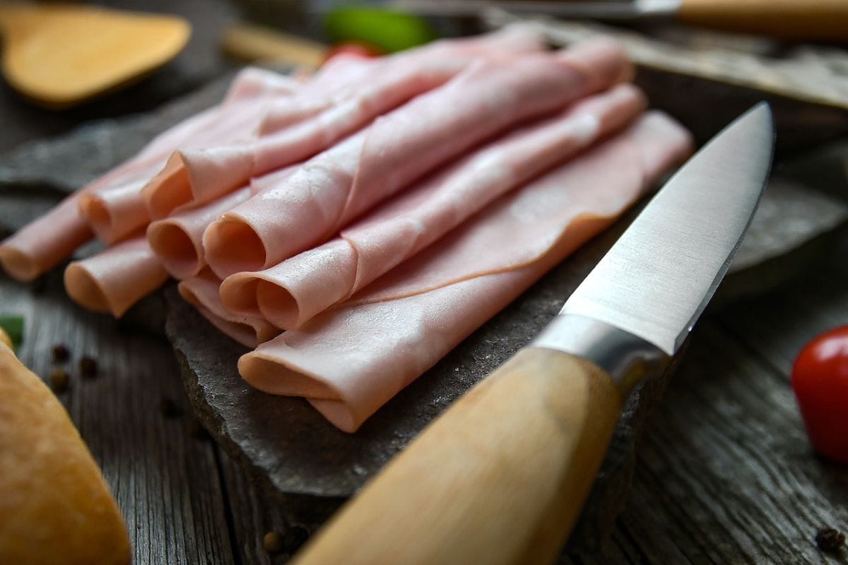 Sliced Ham Beside a Knife
