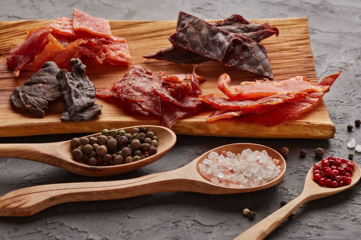 Various Kinds of Dried Spiced Meat on the Wooden Board