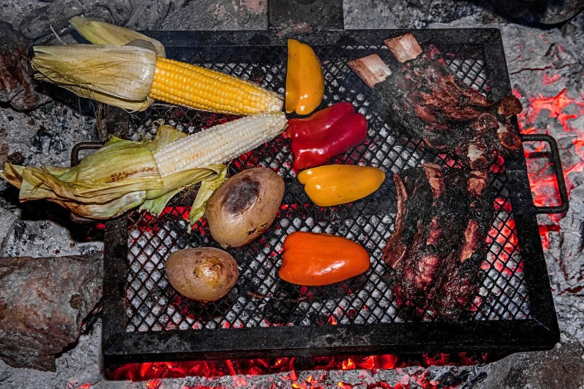 Grilling Ribs, Corn, Peppers and Potatoes Over an open Fire