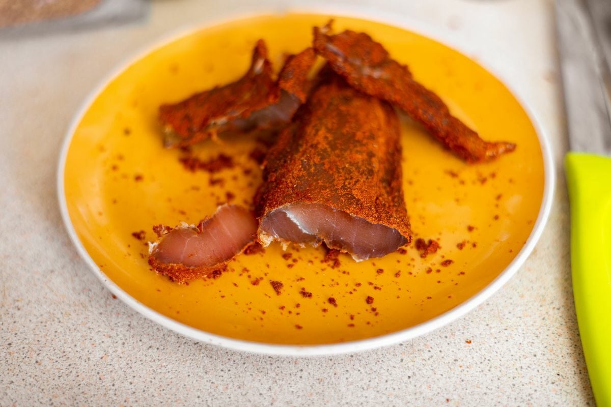 Seasoned Chicken Jerky on a Yellow Plate