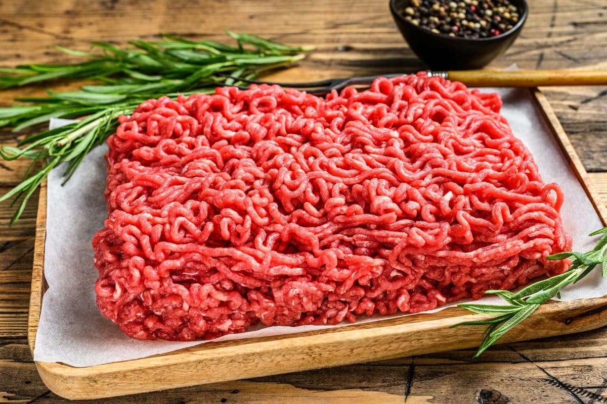 Fresh Raw Ground Meat with Sprig of Rosemary