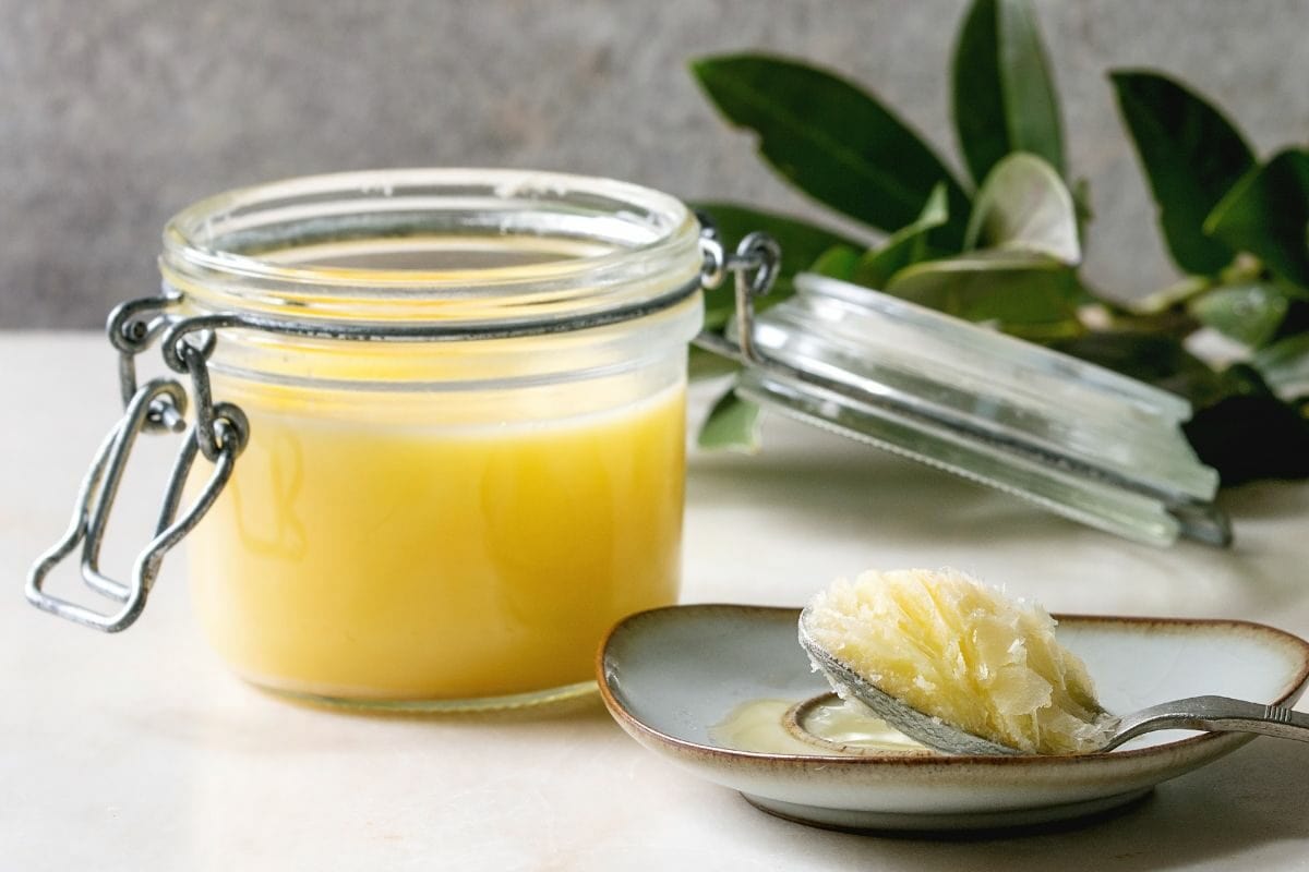 Beef Tallow in Open Glass Jar and Table Spoon