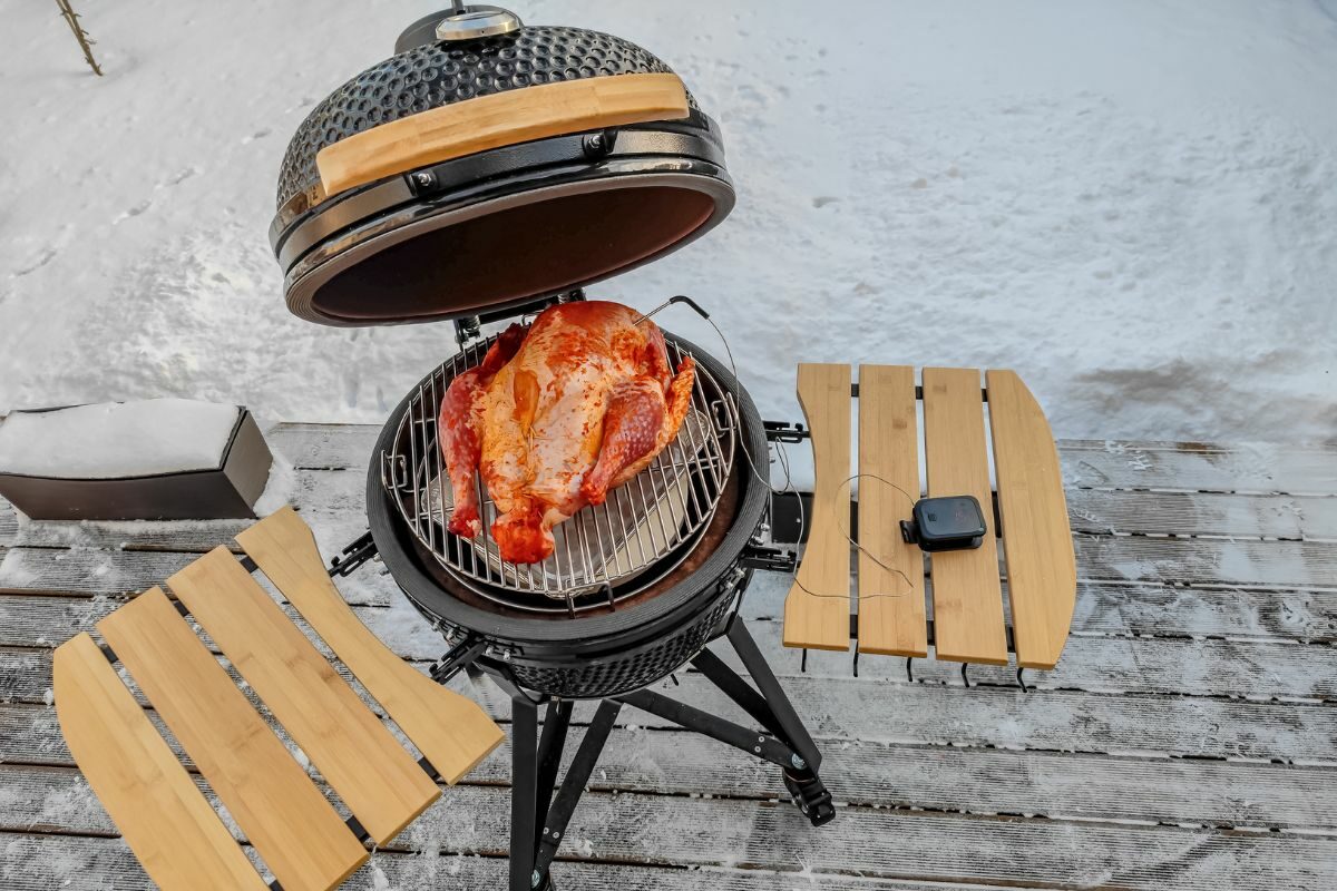 Large Kamado Grill with Turkey Being Grilled in Winter
