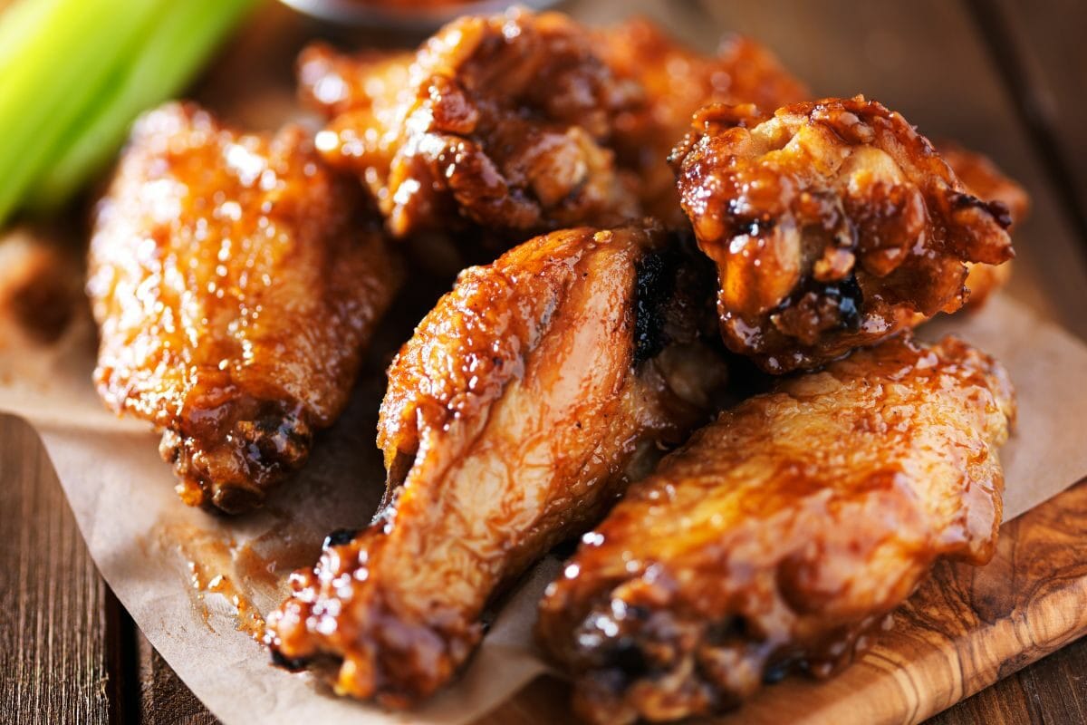 Barbecued Chicken Wings on the Wooden Tray