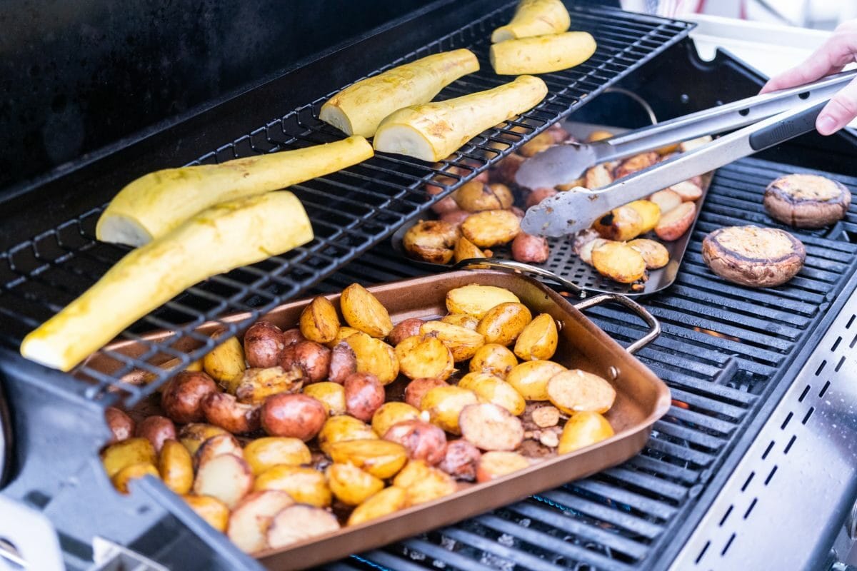 Grilling Small Potatoes with Slices of Garlic on the Gas Grill