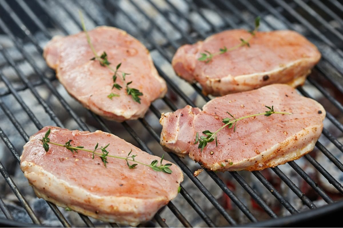 Raw Pieces of Meat on the Grill with Thyme
